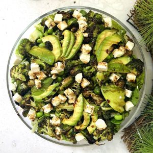 Christmas Green Salad in large wide glass bowl - with avocado, roasted broccoli and Brussel sprouts, feta.